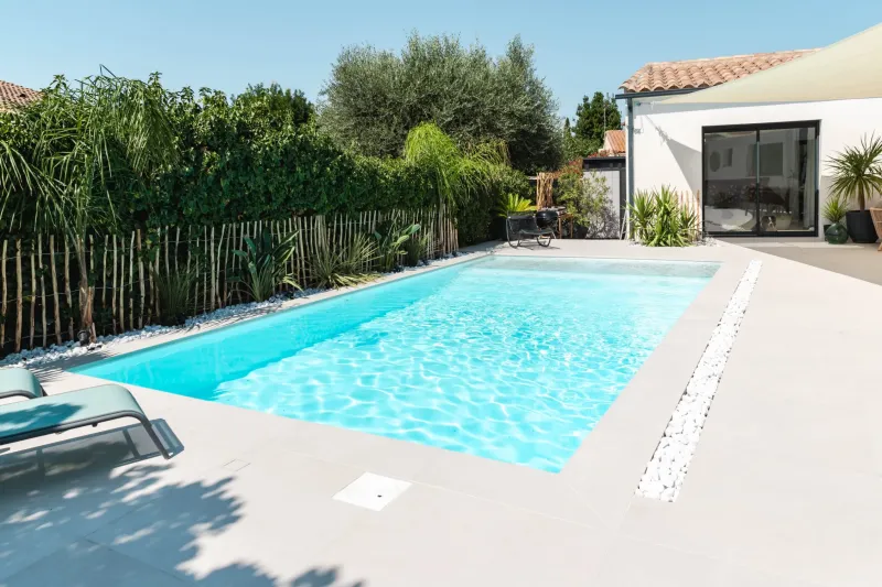 Installation d'une piscine coque modèle AKOYA 7 avec volet immergé à Aigues-Vives à coté de Gallargues-le-montueux , la sécurité et l'esthétisme assurée.