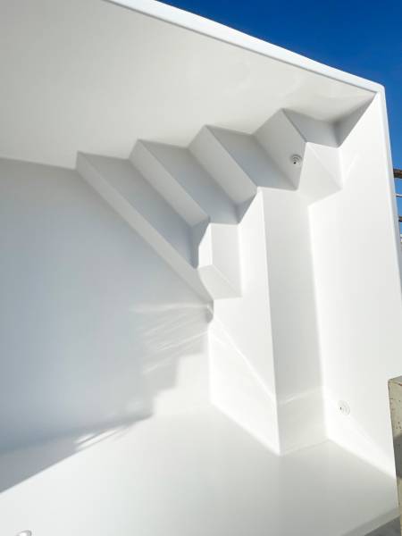Piscine coque polyester modèle Tanna à Vergèze – Compacte et élégante avec banquette et escaliers d'angle